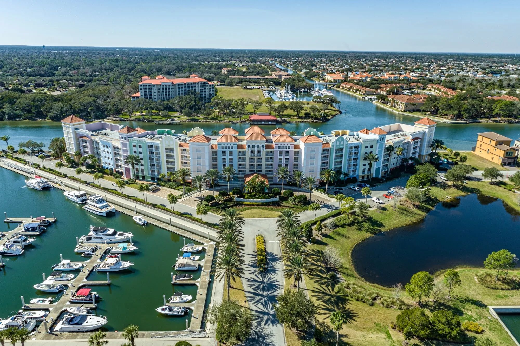 image Marina with boats moored beneath the resort's red-roofed tower