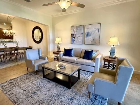 image Open-plan living and dining area with natural light and comfortable seating
