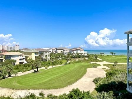 image Sweeping view from the balcony — green golf fairways rolling out toward the Atlantic