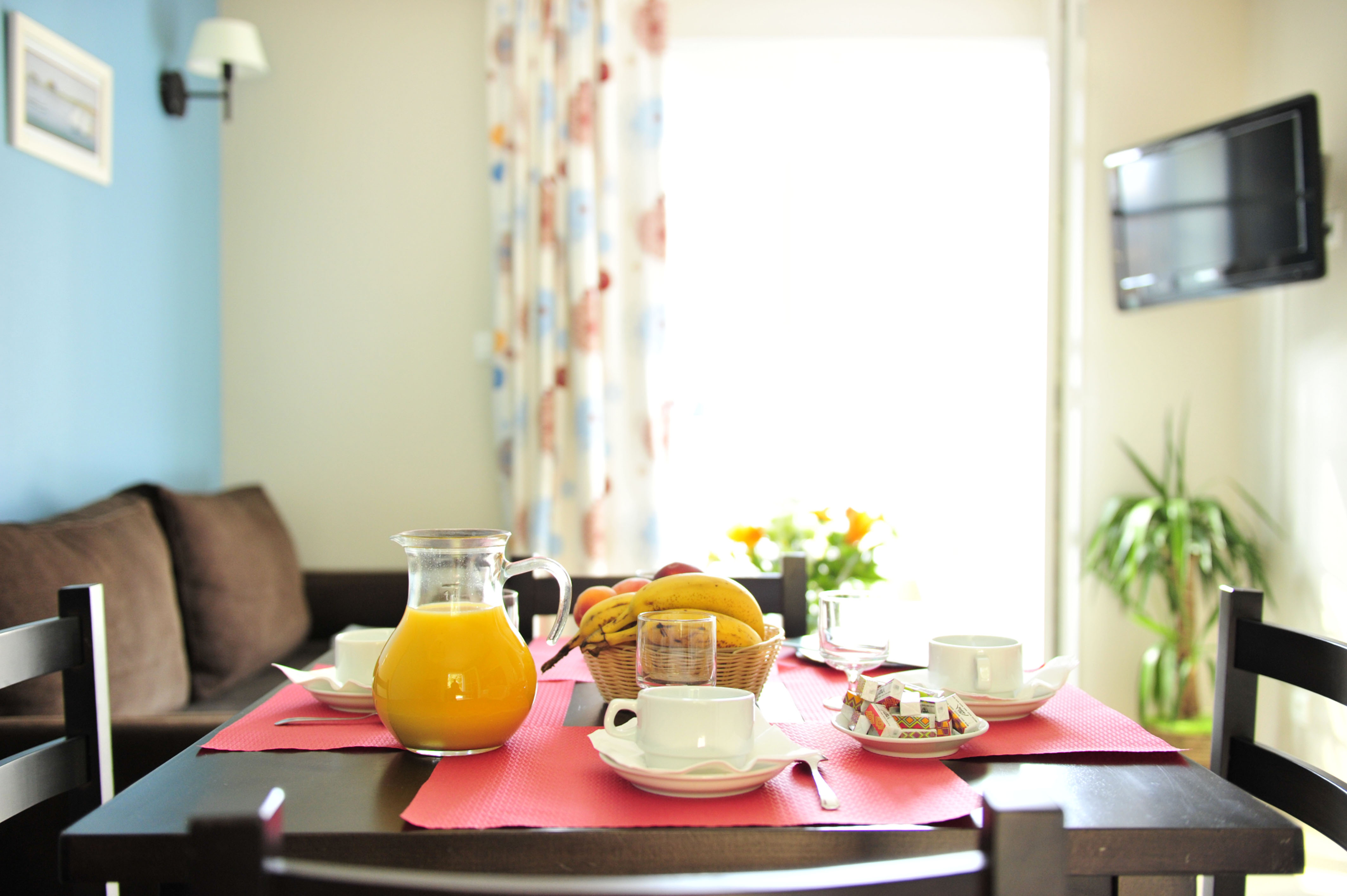 image Bright mornings by the glass door leading out to the terrace and garden furniture beyond.