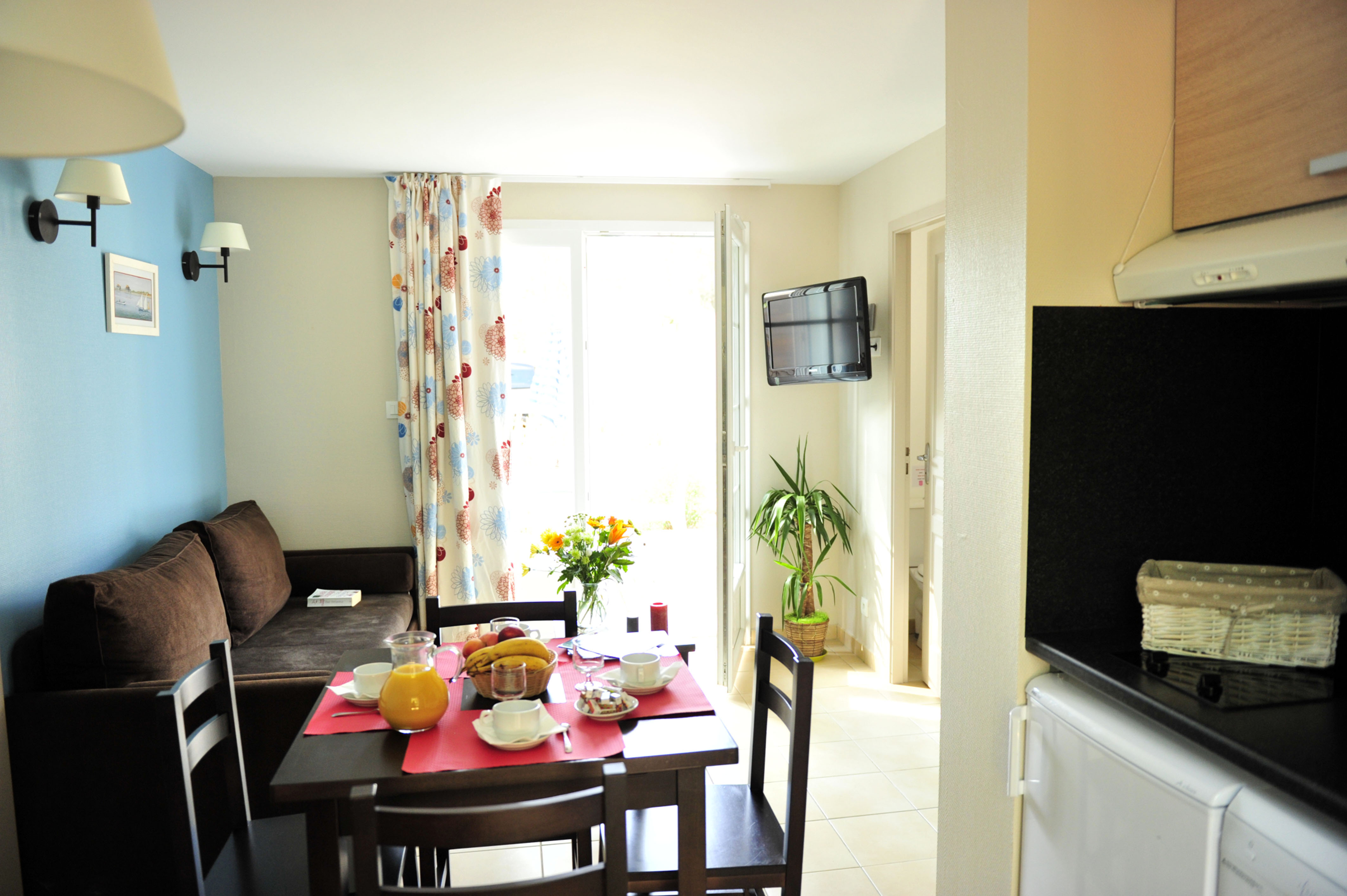 image The open living area comes with a dining table set for breakfast before the walk to the beach.