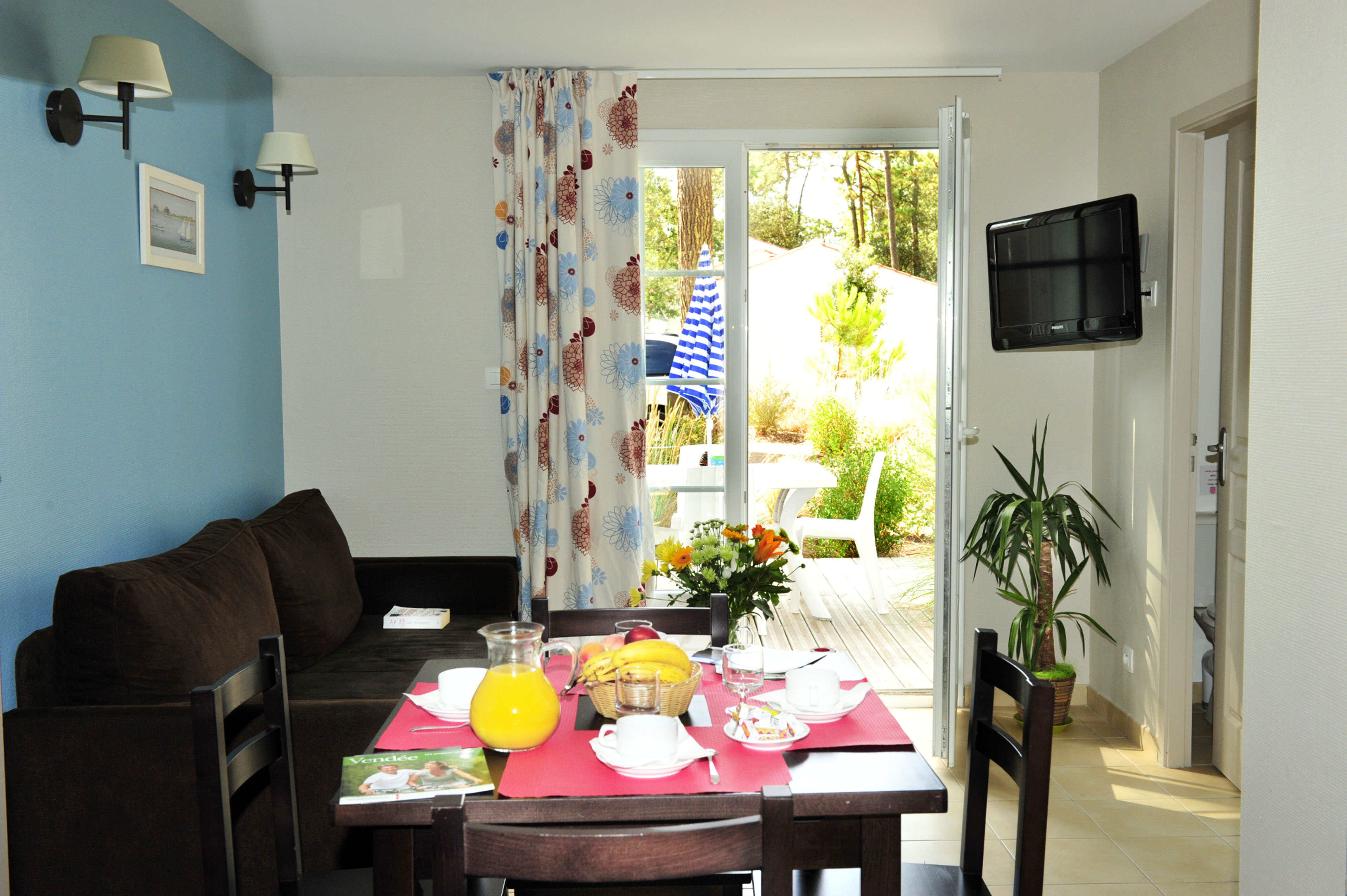 image Blue accents and a garden view set the tone for breakfast before a day at the beach or pool.