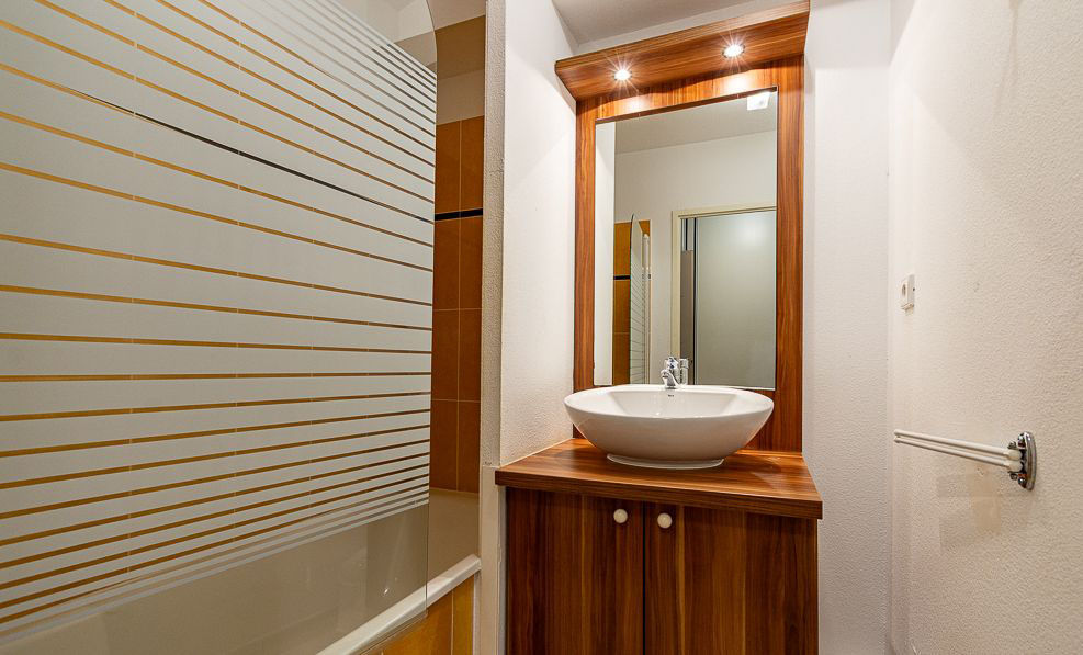 image The bathroom's walk-in shower offers a quick rinse after a day outdoors or a soak in the residence pool.