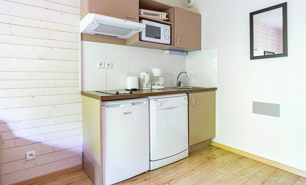 image The dishwasher and hob keep the kitchenette ready for cooking after a day on the mountain, any season.