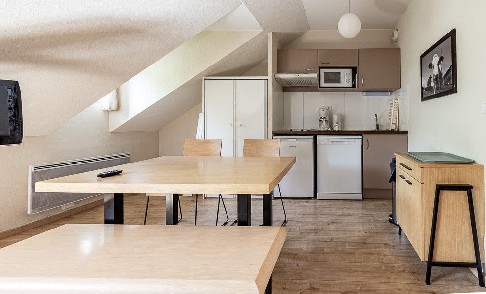 image The kitchenette sits under the sloped roofline, stocked for cooking between days on the trails or pistes.