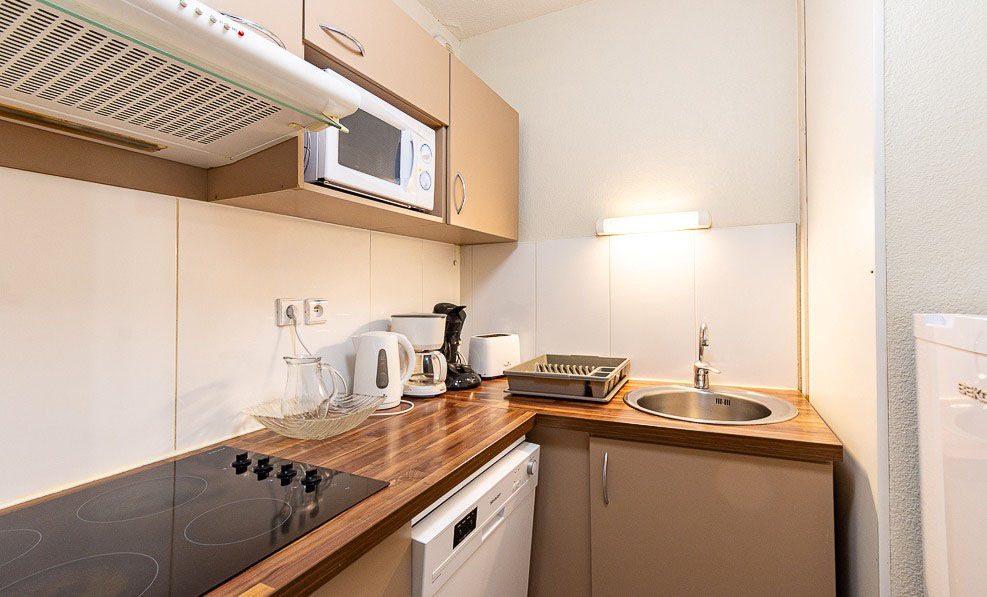 image The kitchenette's dishwasher and cooktop keep self-catering simple between trips up the gondola.
