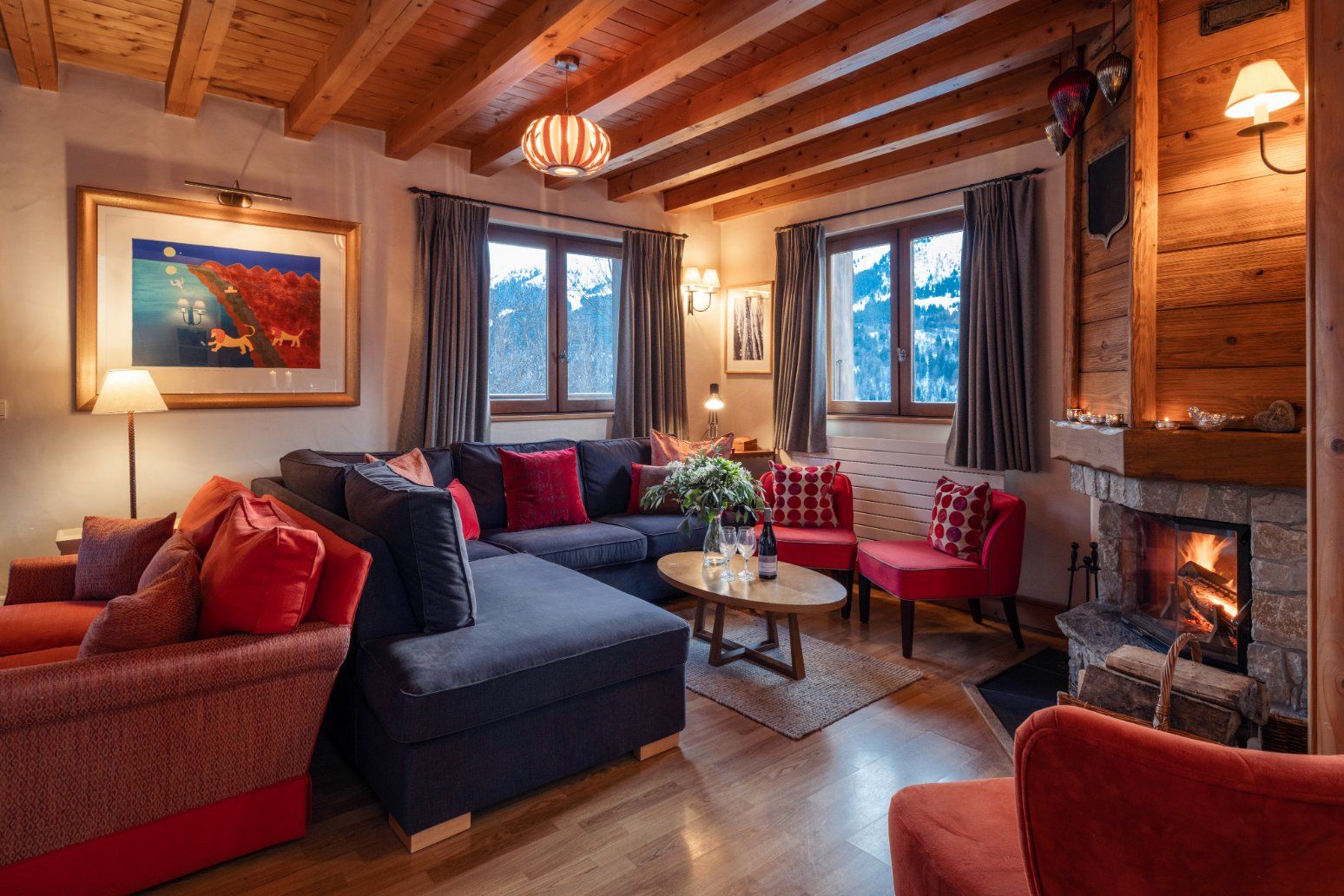 image After a day on the pistes, relax by the stone fireplace in this inviting living area.
