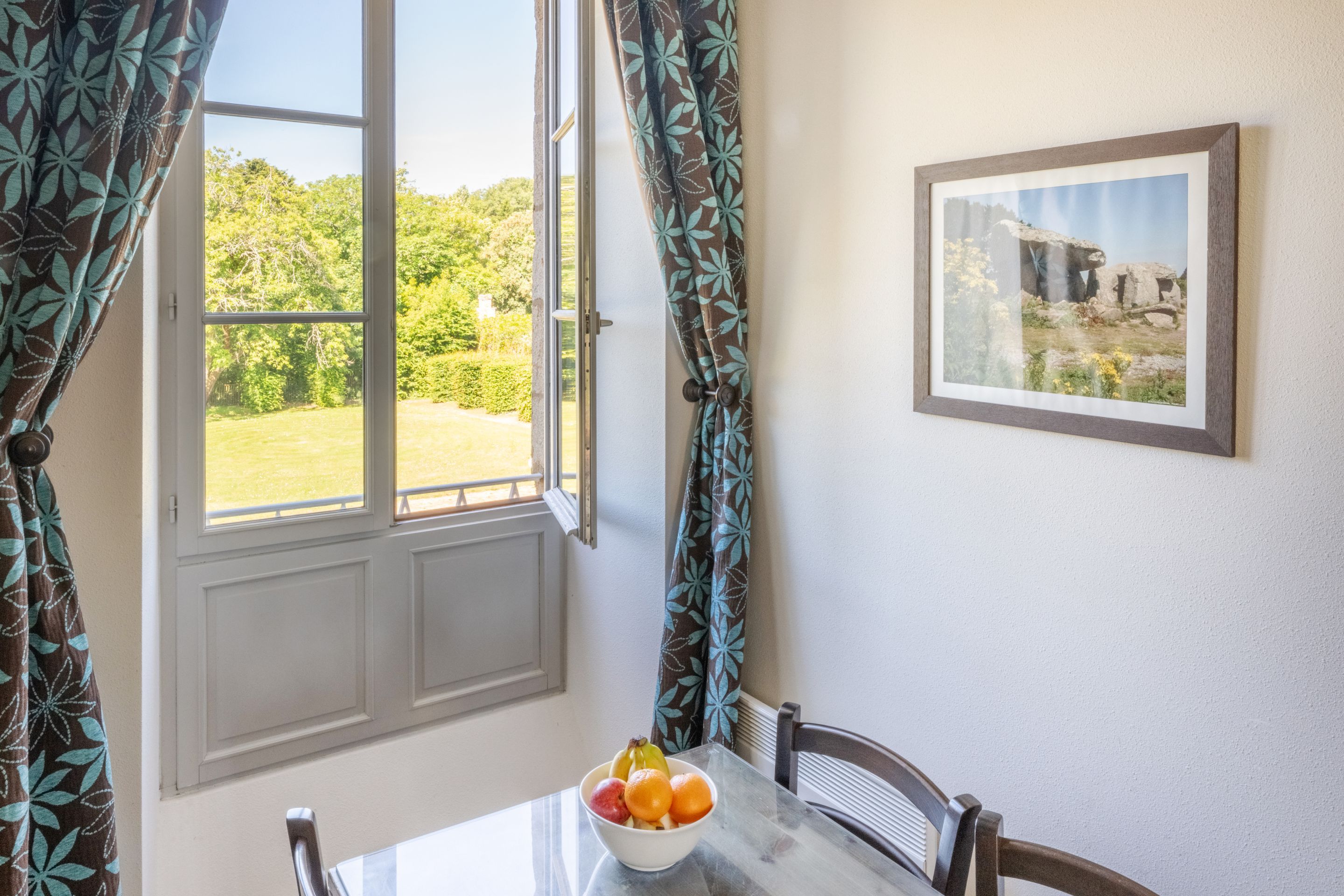 image The dining nook looks out over the chateau gardens, a quiet spot for breakfast before a day of golf or the coast.
