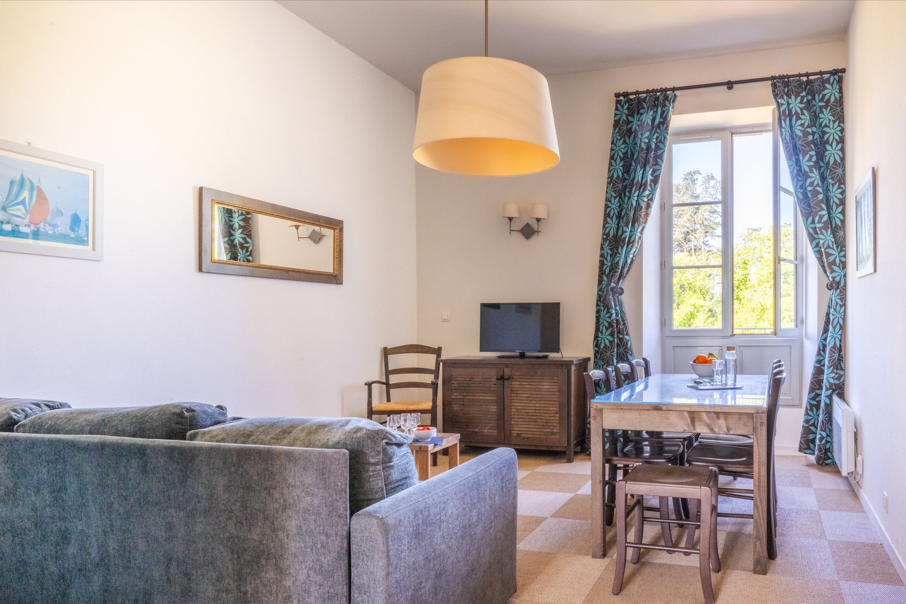image Sunlight fills the living area, where the sofa doubles as a bed when you need the extra space.