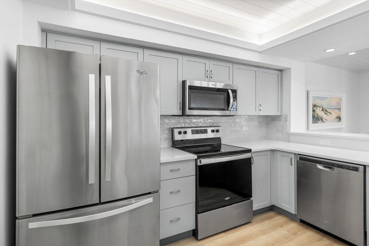 image Cook up a meal in the kitchen, equipped with a refrigerator, microwave, oven, and cooktop.