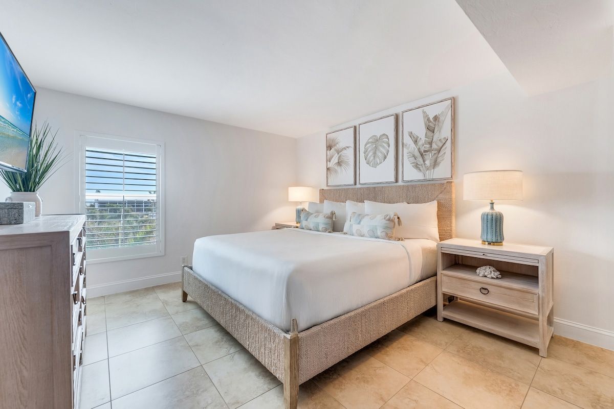 image Bright bedroom with a comfortable bed, matching nightstands, and modern wall art.