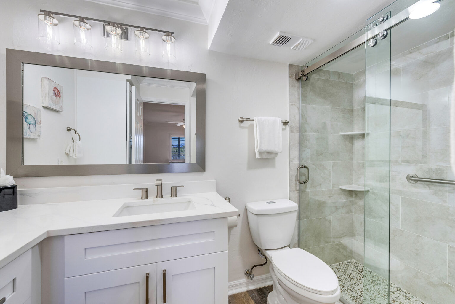 image This bathroom includes a sink and toilet, finished with light-toned surfaces.