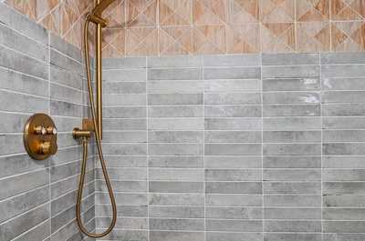 Tiled shower with geometric patterns and good natural ventilation.