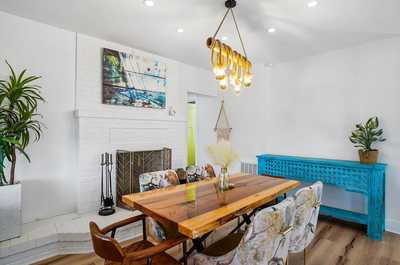 Stylish dining table at the heart of a well-lit, open-plan living area.