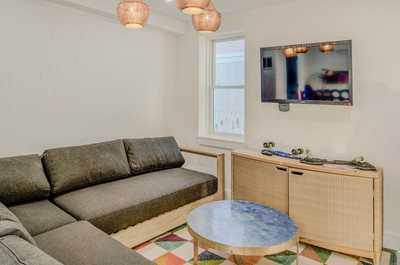 Modern lounge with relaxed furnishings and an inviting colorful patterned floor.