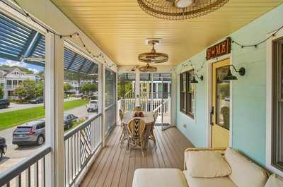 Outdoor dining setup with a wooden table and open views of the street.