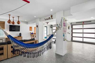 Game room with a pool table, comfortable seating, and vibrant wall art.