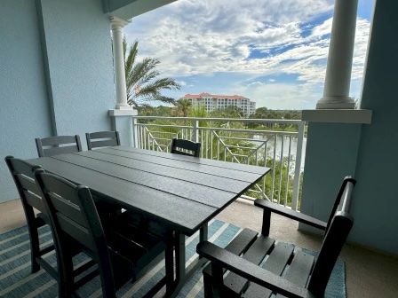 image Private balcony with a large table for outdoor dining overlooking the waterway and green surrounds