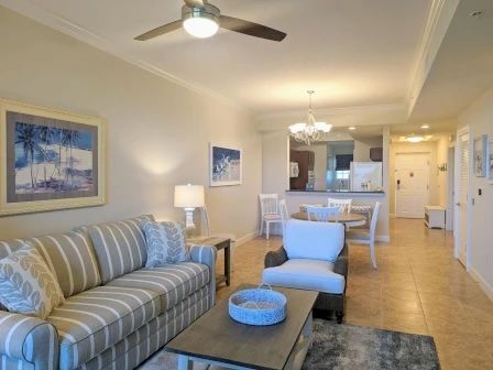 image Living area with soft neutral tones, natural light, and open sightlines to the waterway windows