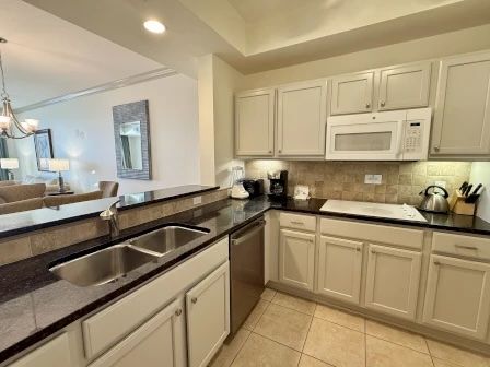 image Kitchen with modern cabinetry, granite counters, and full-sized appliances for group cooking