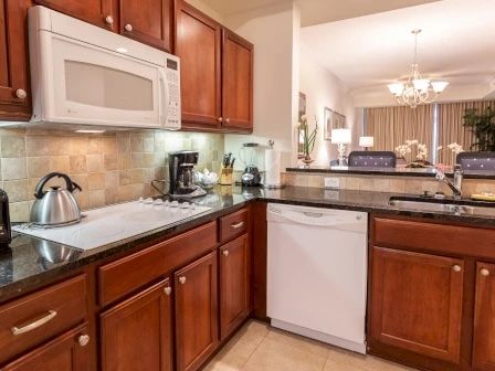 image Kitchen with rich wood cabinetry, granite counters, and a full set of stainless appliances