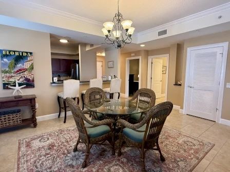 image Glass-top dining table with tropical decor and seating for the group