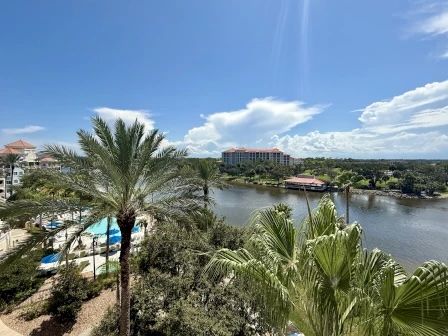 image Intracoastal view from the balcony with swaying palms — sunlight on the water all morning