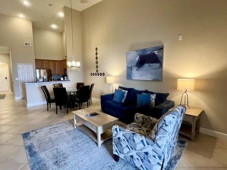image Living area with soft blue accents, plush seating, and natural light through large windows