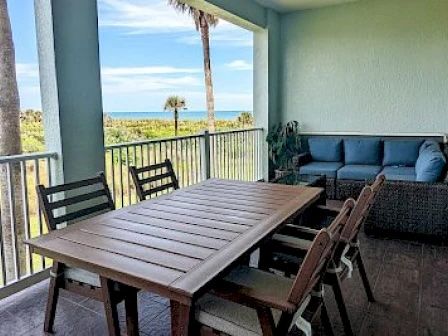 image Private balcony with seating overlooking the ocean and golf course — morning coffee here never gets old