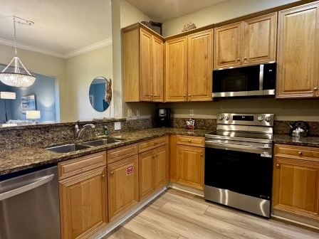 image Kitchen with granite counters, stainless steel appliances, and a two-seat kitchen bar