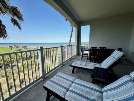 image Private balcony with seating and ocean views — a quiet spot for morning coffee or an evening drink