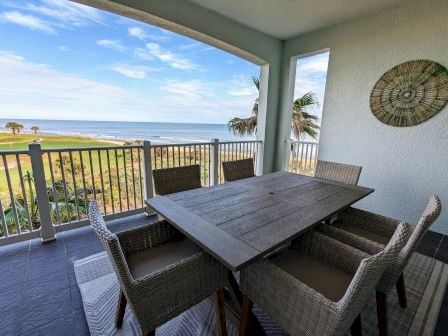 image Private balcony with wraparound ocean and golf course views — room for al fresco dining under the palms