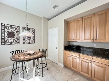 image Round dining table beside a bright window — a good spot for breakfast or casual group meals