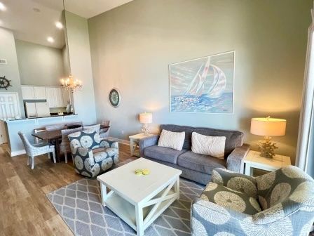 image Living area with plush seating, soft coastal tones, and a flat-screen TV for group downtime