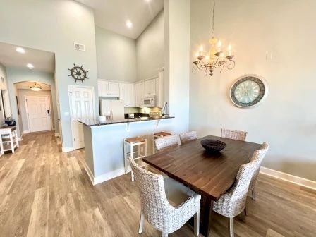 image Rustic dining table with wicker chairs for six — open to the kitchen for easy family meals