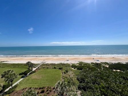 image Sun on the water and beach below — the view from the balcony changes all day as the light shifts
