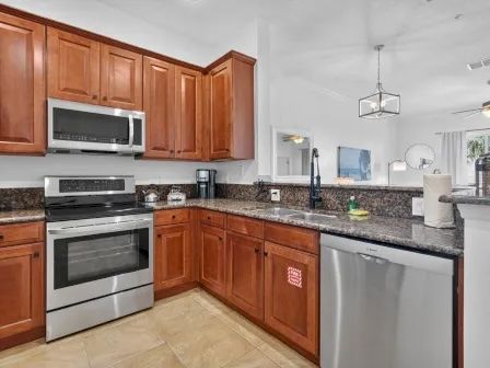 image Kitchen with rich cabinetry, stainless steel appliances, and counter space for full meal prep
