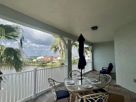 image Private balcony with table and chairs overlooking the lake — morning coffee with a view