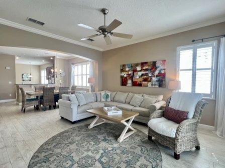 image Living area with comfortable seating, vibrant coastal artwork, and open flow to the kitchen