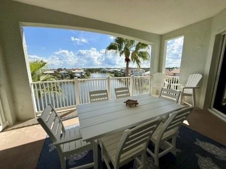 image Balcony table with two chairs and lake views on all sides — a good spot morning or evening
