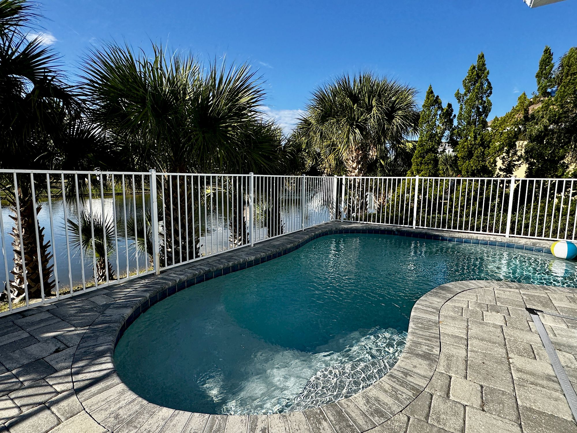 image Your waterfront-facing private pool with swaying palms — the covered lanai and gas grill are just steps away
