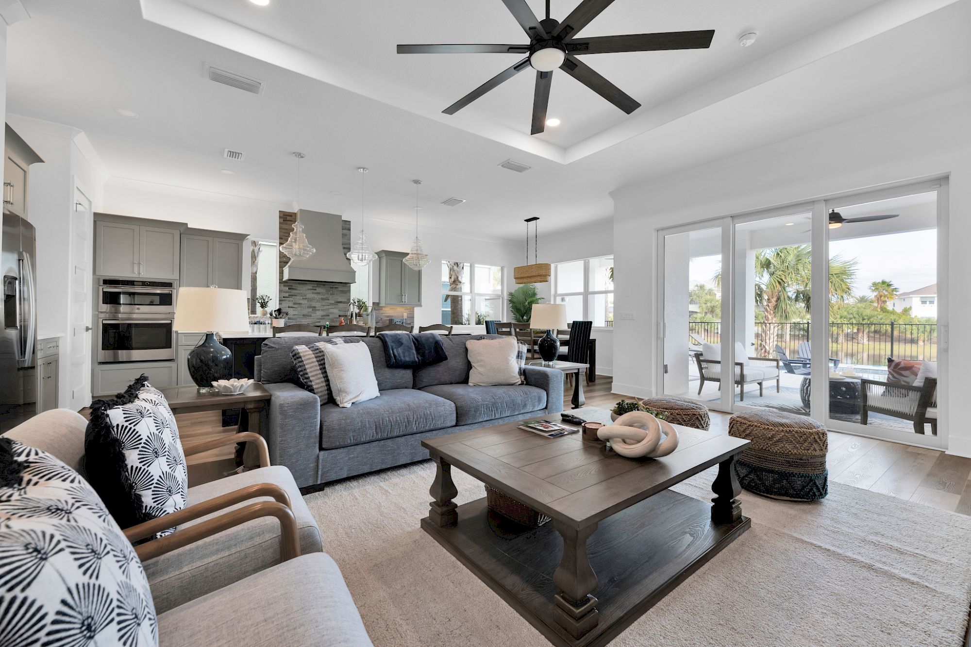 image Light-filled living area with comfortable seating and an electric fireplace for cool evenings