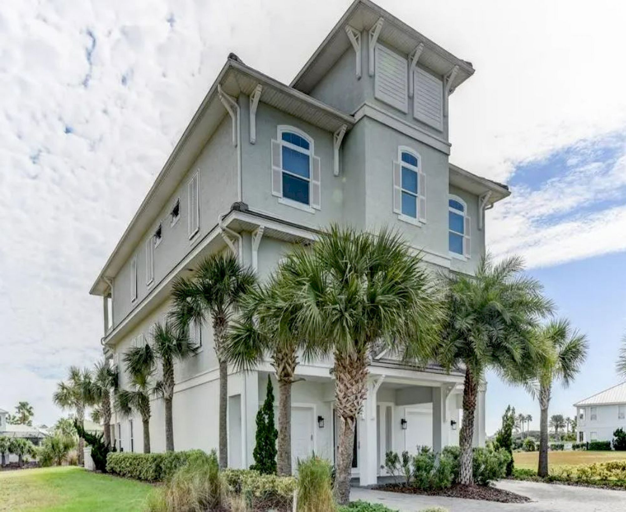image Multi-story exterior with lake-view balconies wrapping every floor and lush palms at the entrance