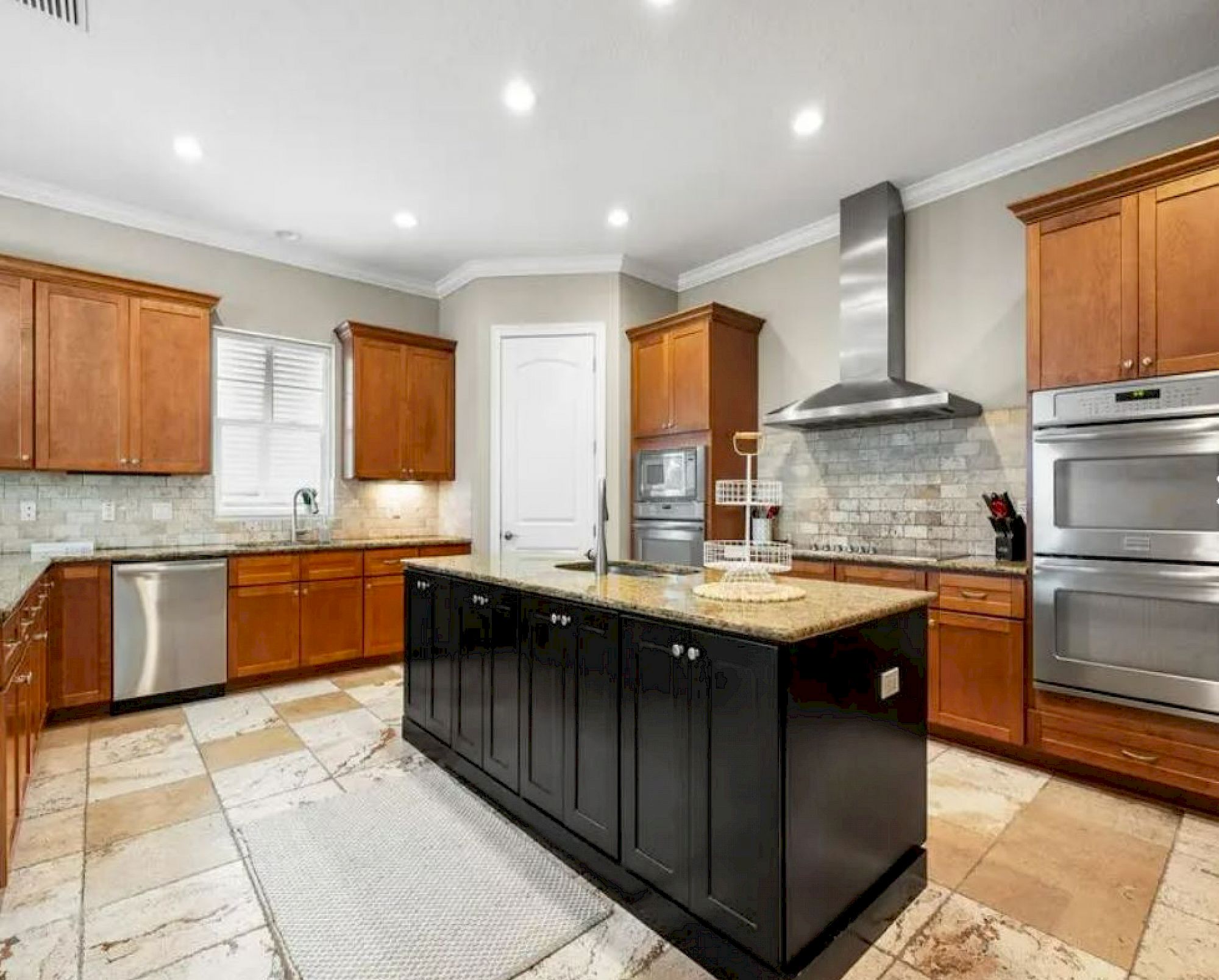 image Kitchen with granite counters, stainless appliances, and room for the whole group to cook