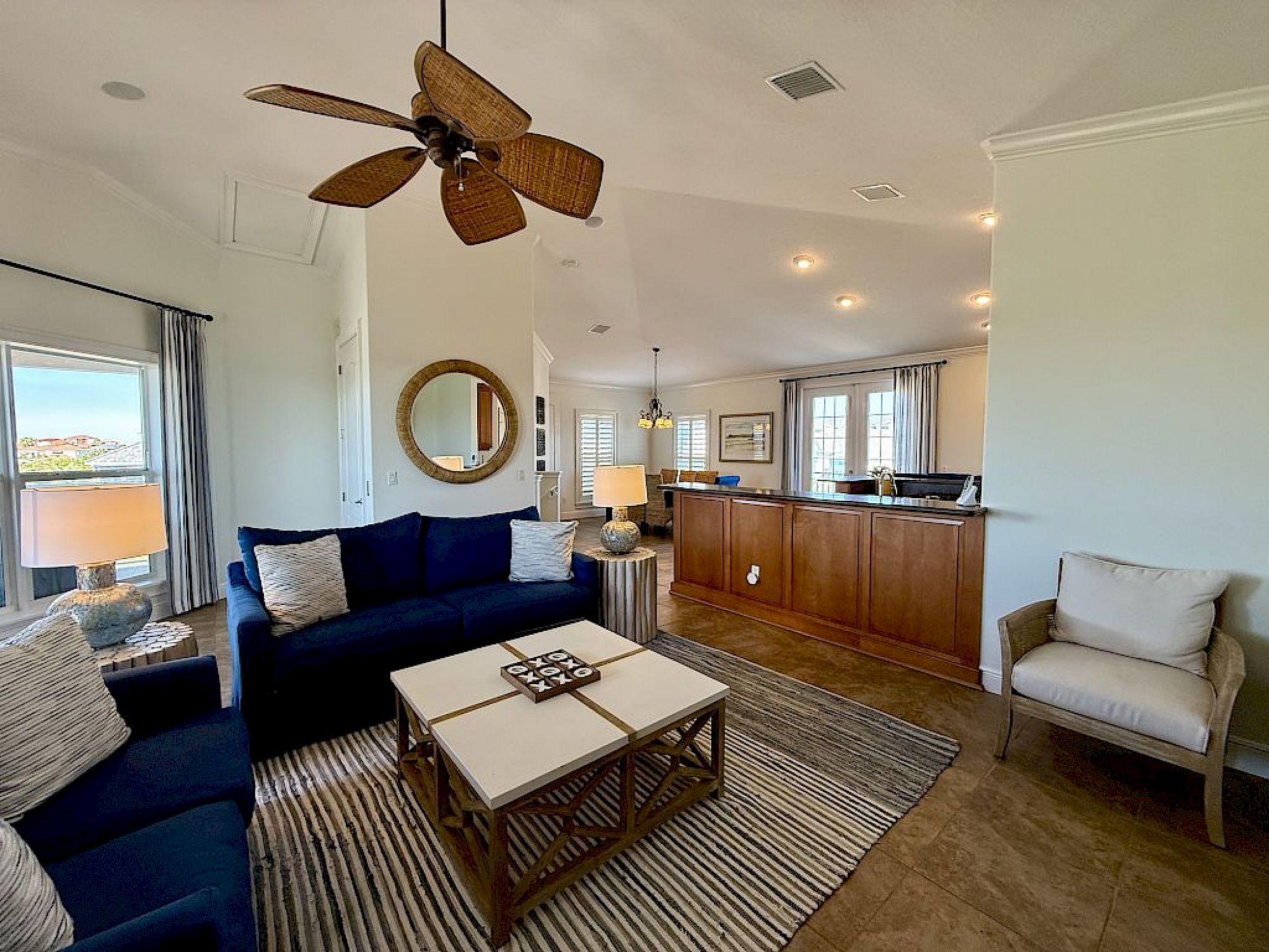 image Open-concept living area with soaring ceilings, natural light, and plush seating on multiple levels