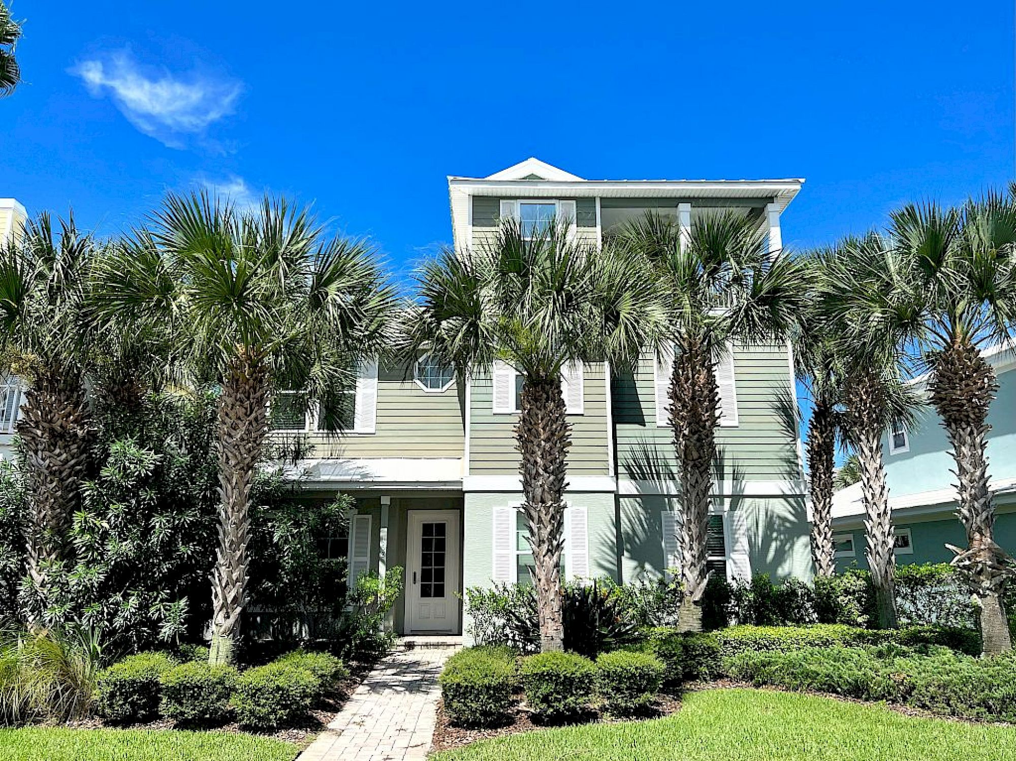 image Palm-lined entrance with a covered walkway — the pool and spa courtyard are just through the gate