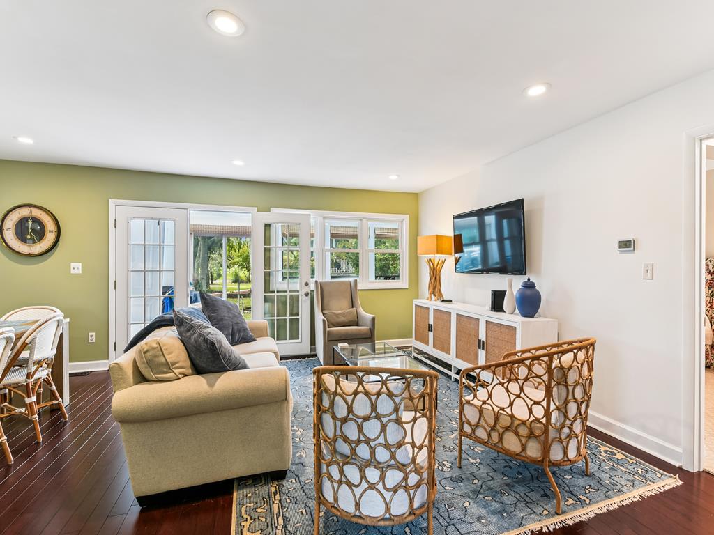 image Plush sofa seating and a smart TV in the living room -- your go-to spot for movie nights after the beach