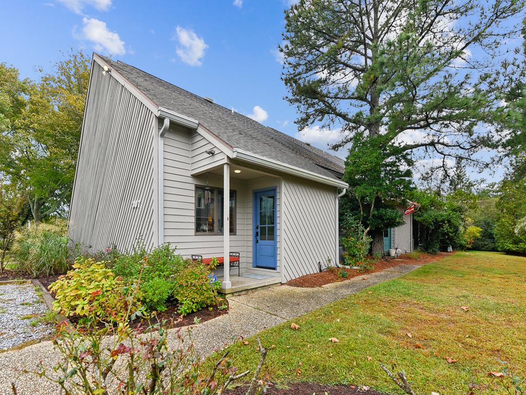 image Step into your beach retreat with lush greenery and charming doors, just moments from the sandy shore and Boardwalk