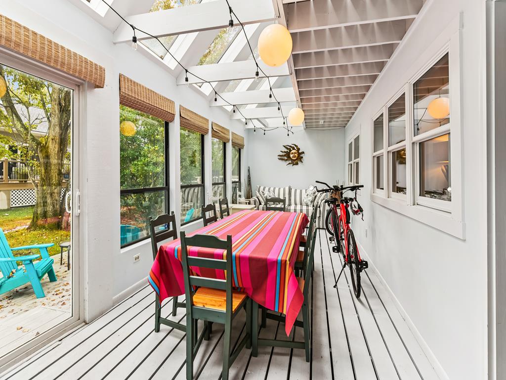 image Three-season porch with a colorful dining table -- a bright spot for meals and lazy afternoons