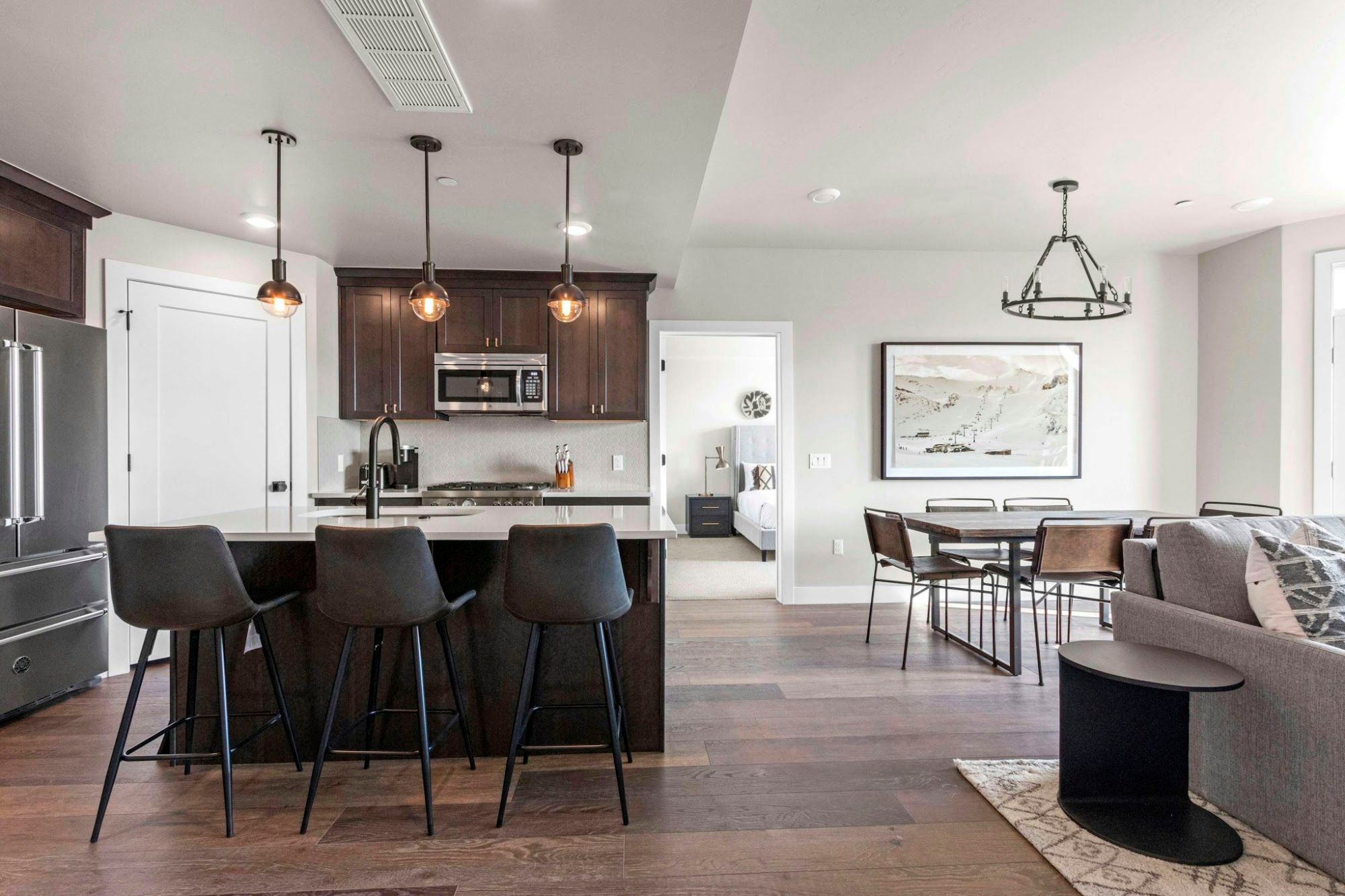 image Open kitchen with island seating, dining area, and view into the bedroom